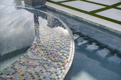 a swimming pool with outdoor seating