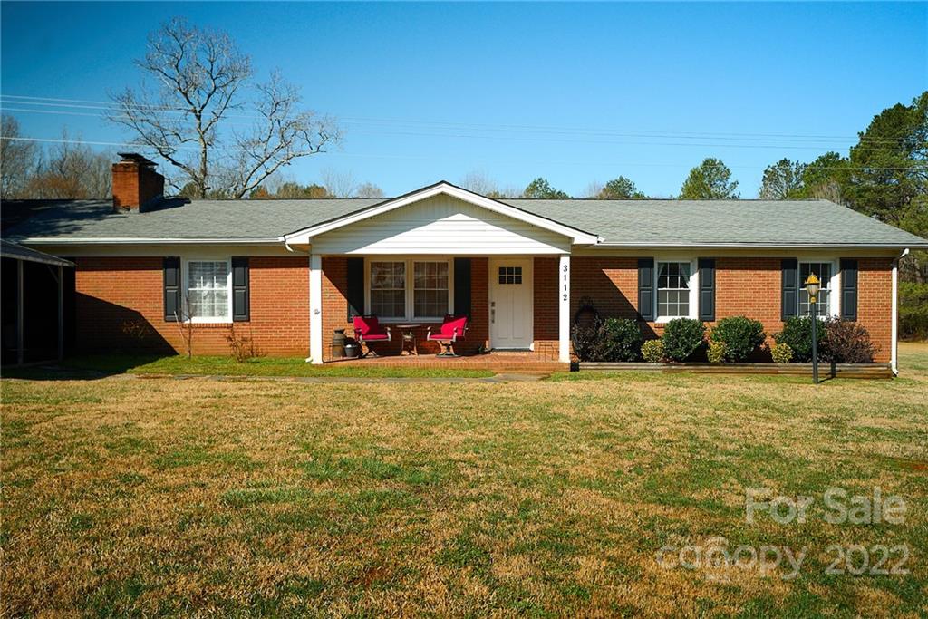 3112 Wolf Pond Road Monroe, NC 28112 - Photo 1 of 29 a front view of a house with garden