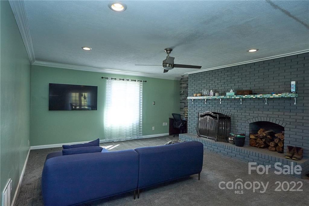 3112 Wolf Pond Road Monroe, NC 28112 - Photo 11 of 29 a living room with furniture and a fireplace