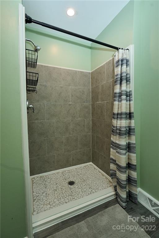 3112 Wolf Pond Road Monroe, NC 28112 - Photo 14 of 29 a bathroom with a shower and a sink