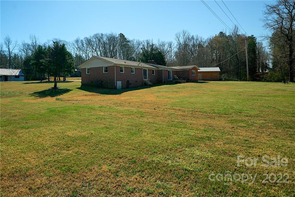 3112 Wolf Pond Road Monroe, NC 28112 - Photo 27 of 29 a view of a swimming pool with a yard