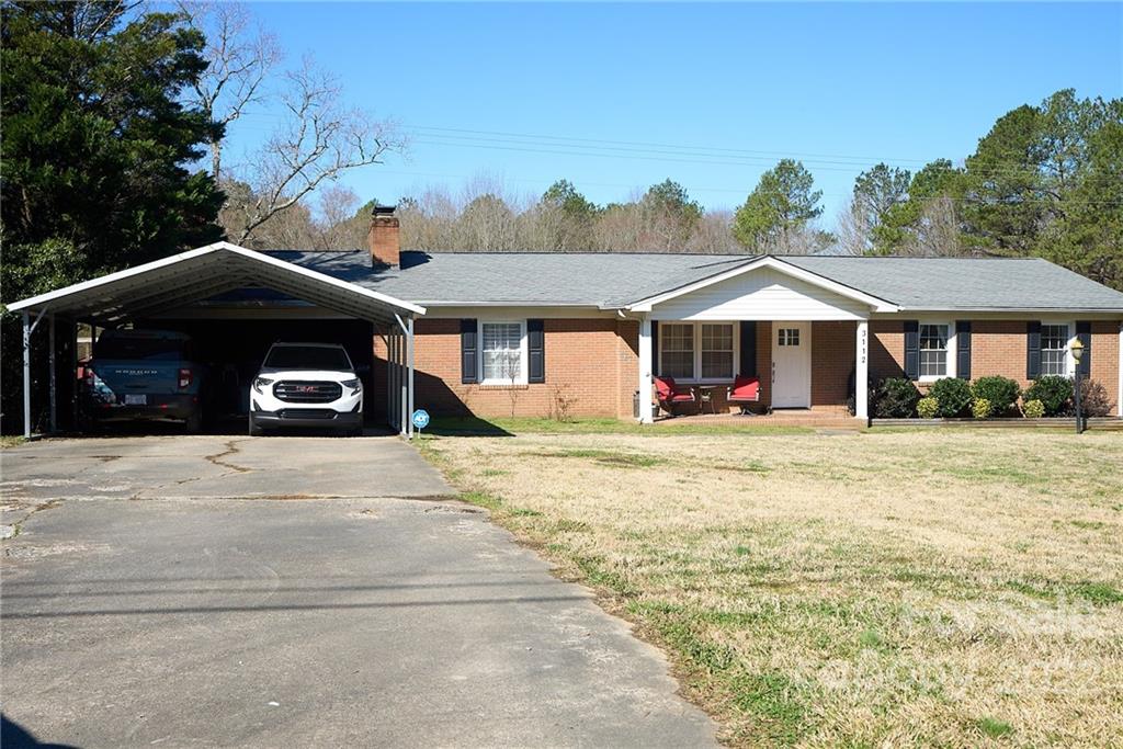 3112 Wolf Pond Road Monroe, NC 28112 - Photo 3 of 29 a front view of a house with a yard