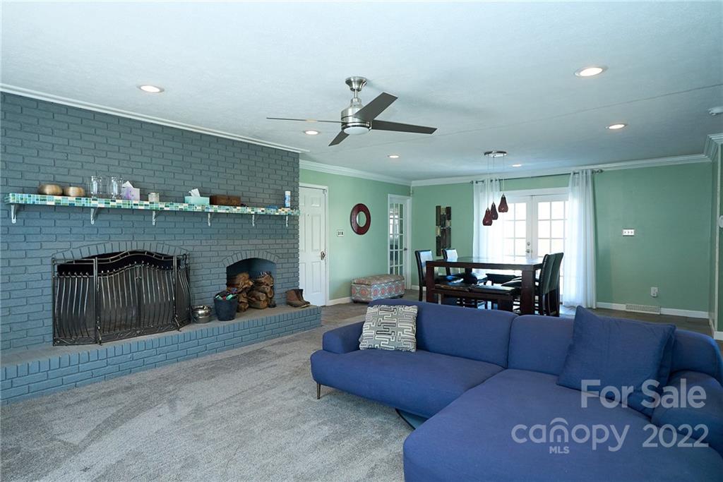 3112 Wolf Pond Road Monroe, NC 28112 - Photo 9 of 29 a living room with furniture and a fireplace
