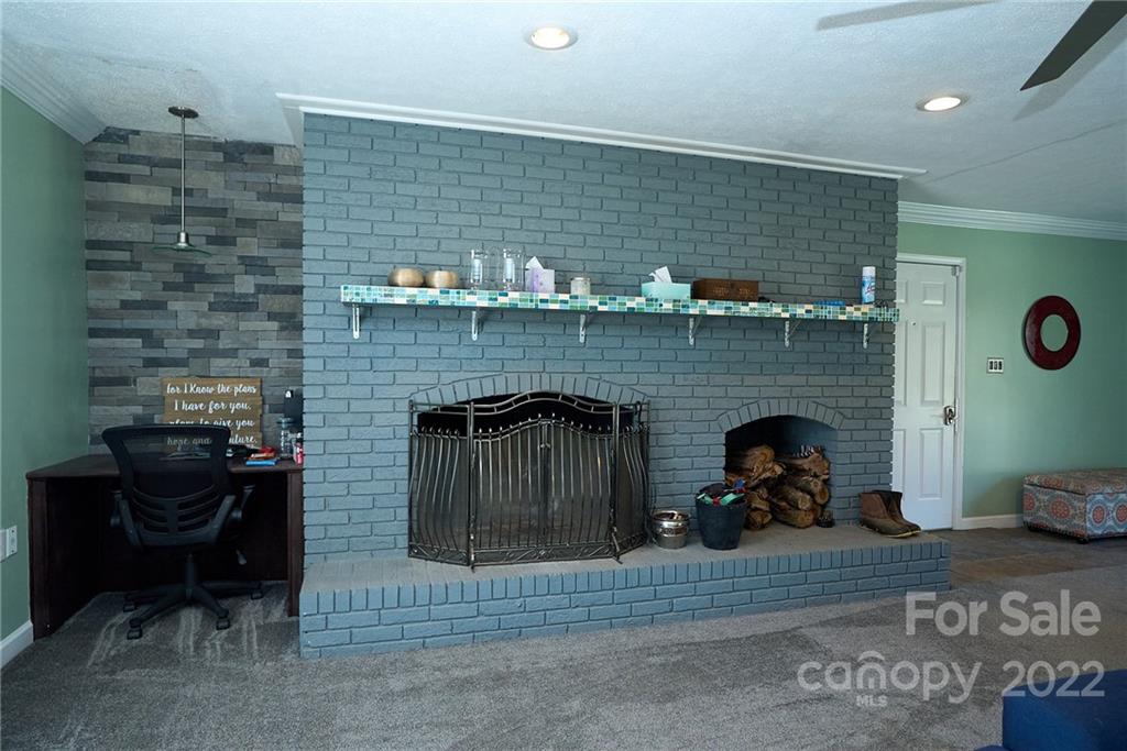 3112 Wolf Pond Road Monroe, NC 28112 - Photo 10 of 29 a living room with furniture and a fireplace