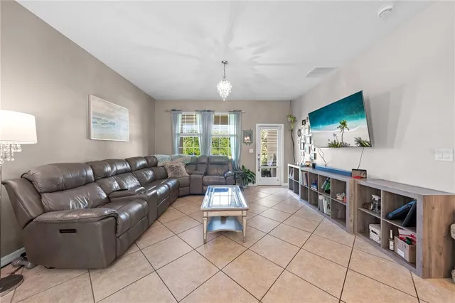 a living room with furniture and kitchen view