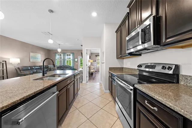 a kitchen with kitchen island a sink table and chairs