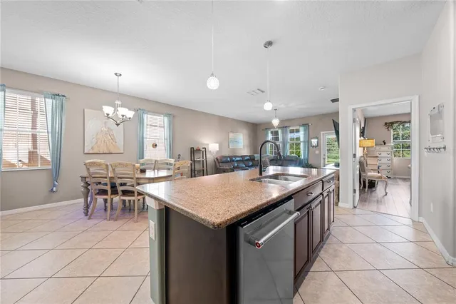 a kitchen with stainless steel appliances granite countertop a sink a stove and a microwave