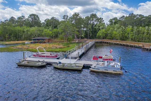 an aerial view of residential houses with outdoor space and swimming pool
