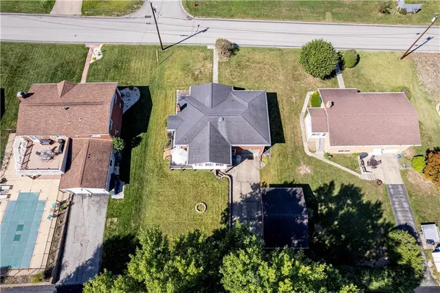 an aerial view of multiple houses with yard