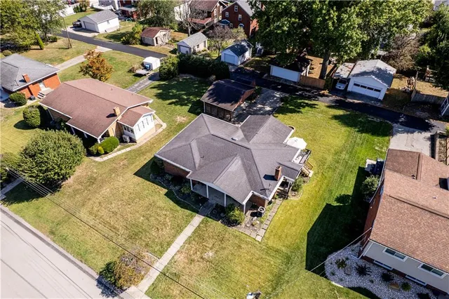 an aerial view of house with yard swimming pool and outdoor seating
