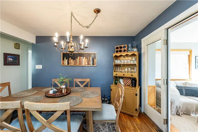 a view of a dining room with furniture and chandelier