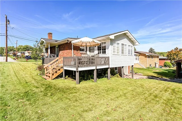 a front view of a house with a yard table and chairs