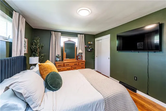 a bedroom with a bed and a television