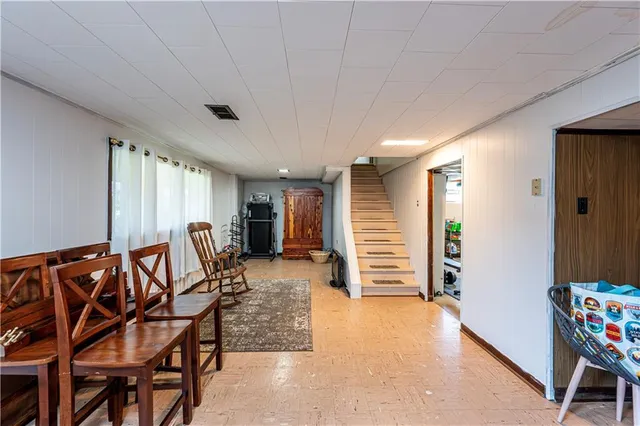 a view of a livingroom with furniture and staircase