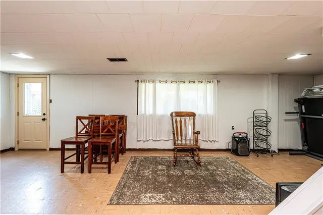 a living room with furniture a wooden floor and a large window