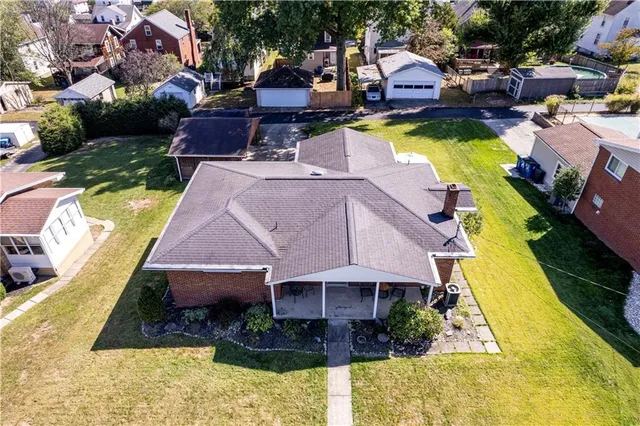 a aerial view of a house with swimming pool and a yard