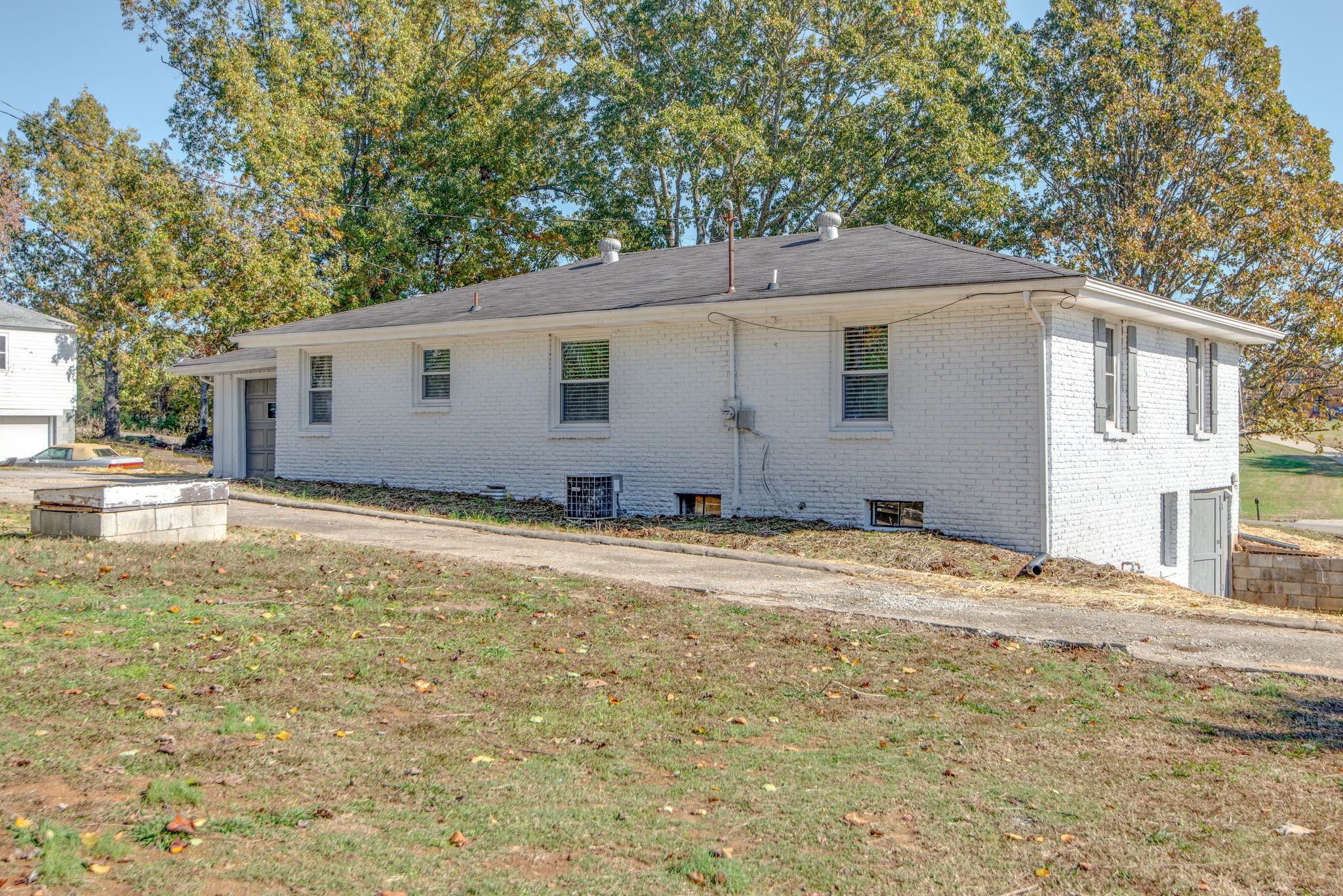 2154 Lake Road Greenbrier, TN 37073 - Photo 21 of 24 a backyard of a house with large trees and wooden fence