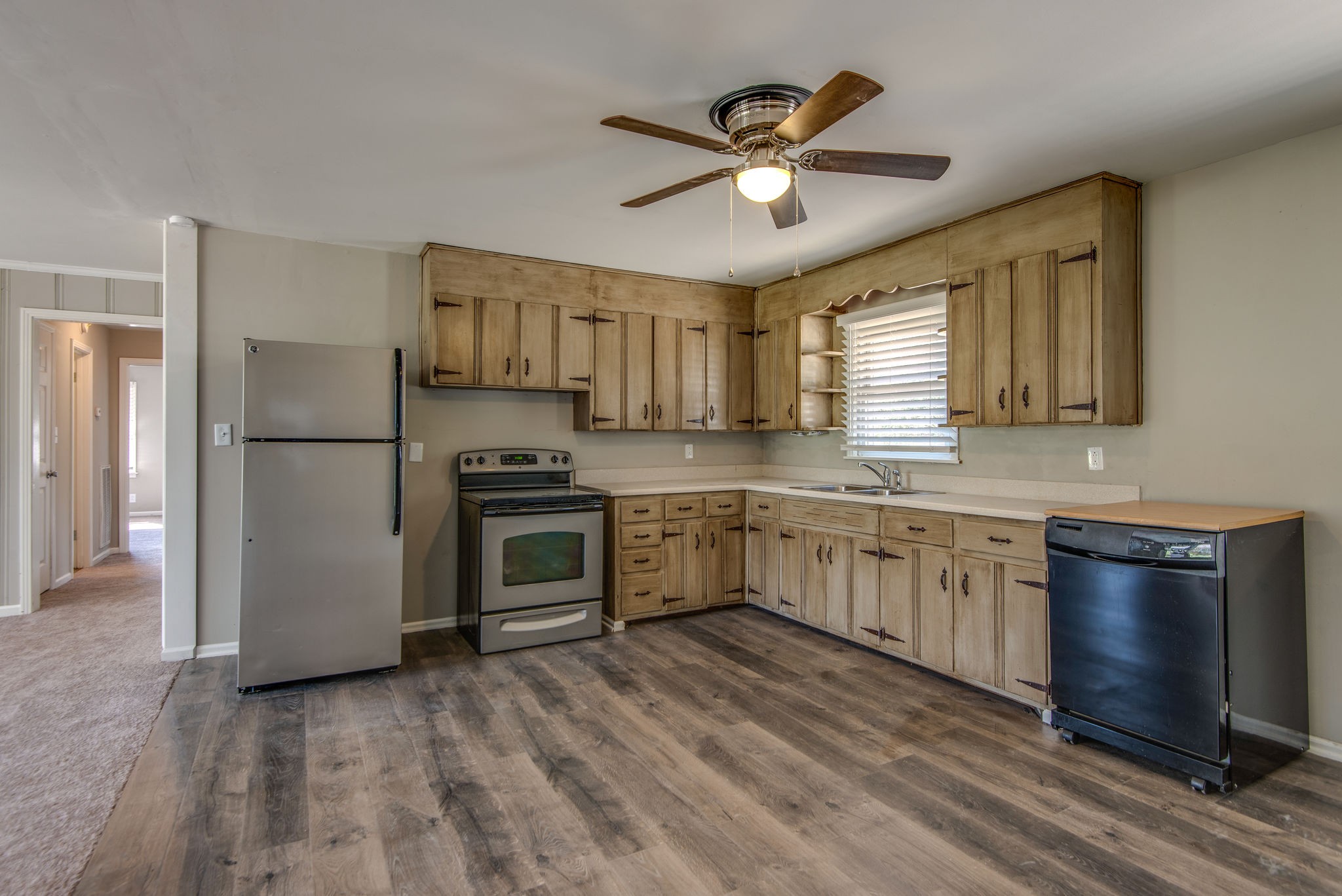 2154 Lake Road Greenbrier, TN 37073 - Photo 4 of 24 a kitchen with stainless steel appliances granite countertop a refrigerator a stove a sink and white cabinets