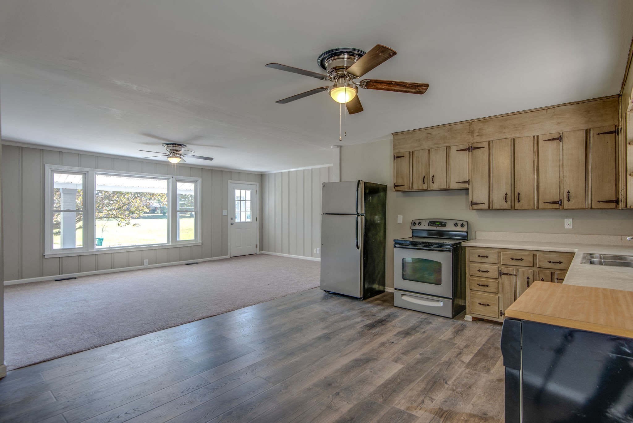 2154 Lake Road Greenbrier, TN 37073 - Photo 7 of 24 a kitchen with stainless steel appliances a stove a refrigerator sink cabinets and wooden floor