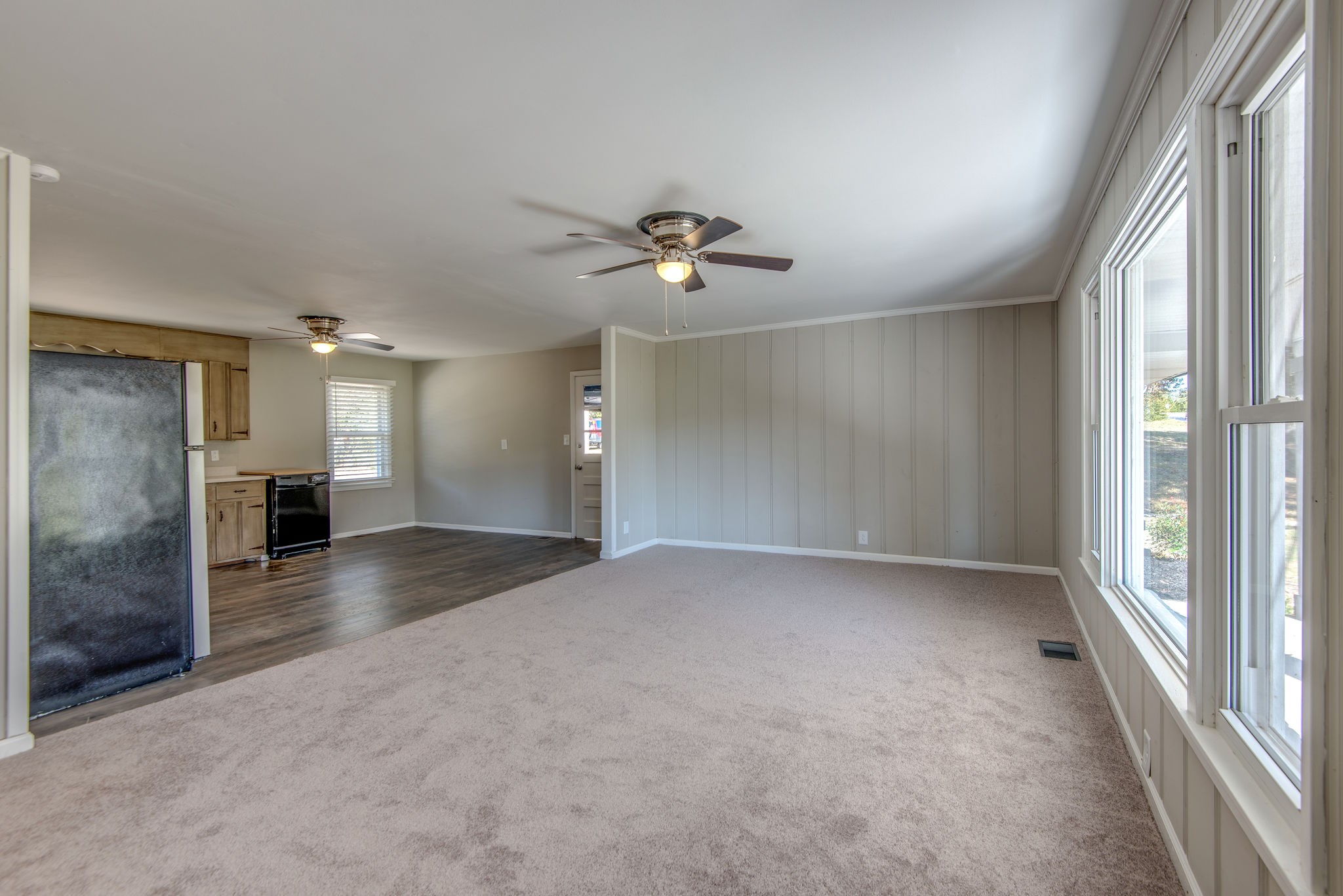 2154 Lake Road Greenbrier, TN 37073 - Photo 8 of 24 an empty room with chandelier fan and windows