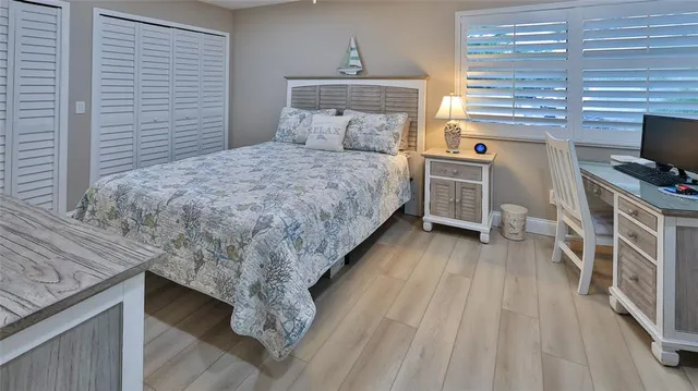 a bed room with a bed and a television