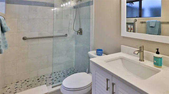 a bathroom with a sink toilet and shower