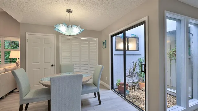 a view of a dining room with furniture wooden floor and a chandelier