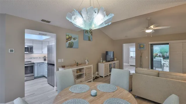 a living room with furniture and a dining table