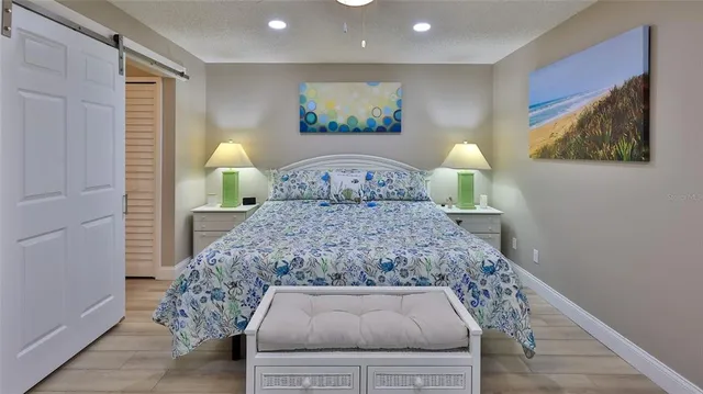 a bedroom with a bed and a painting on the wall