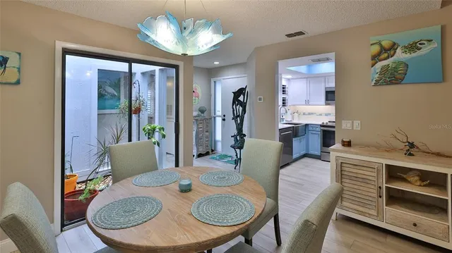 a view of a dining room with furniture wooden floor and chandelier