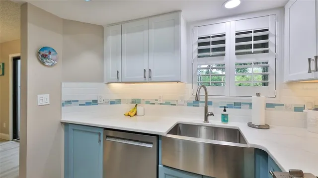a kitchen with a sink and a refrigerator