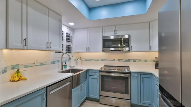 a kitchen with a sink a stove and cabinets