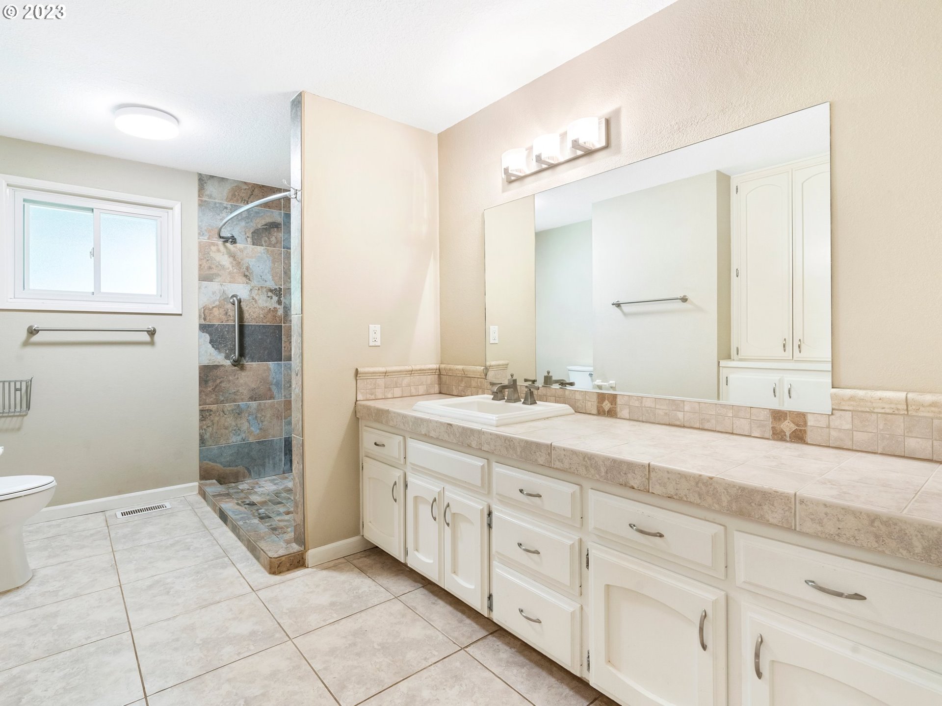 17875 Southwest Shawnee Trail Tualatin, OR 97062 - Photo 18 of 44 a spacious bathroom with a granite countertop sink a mirror and a
