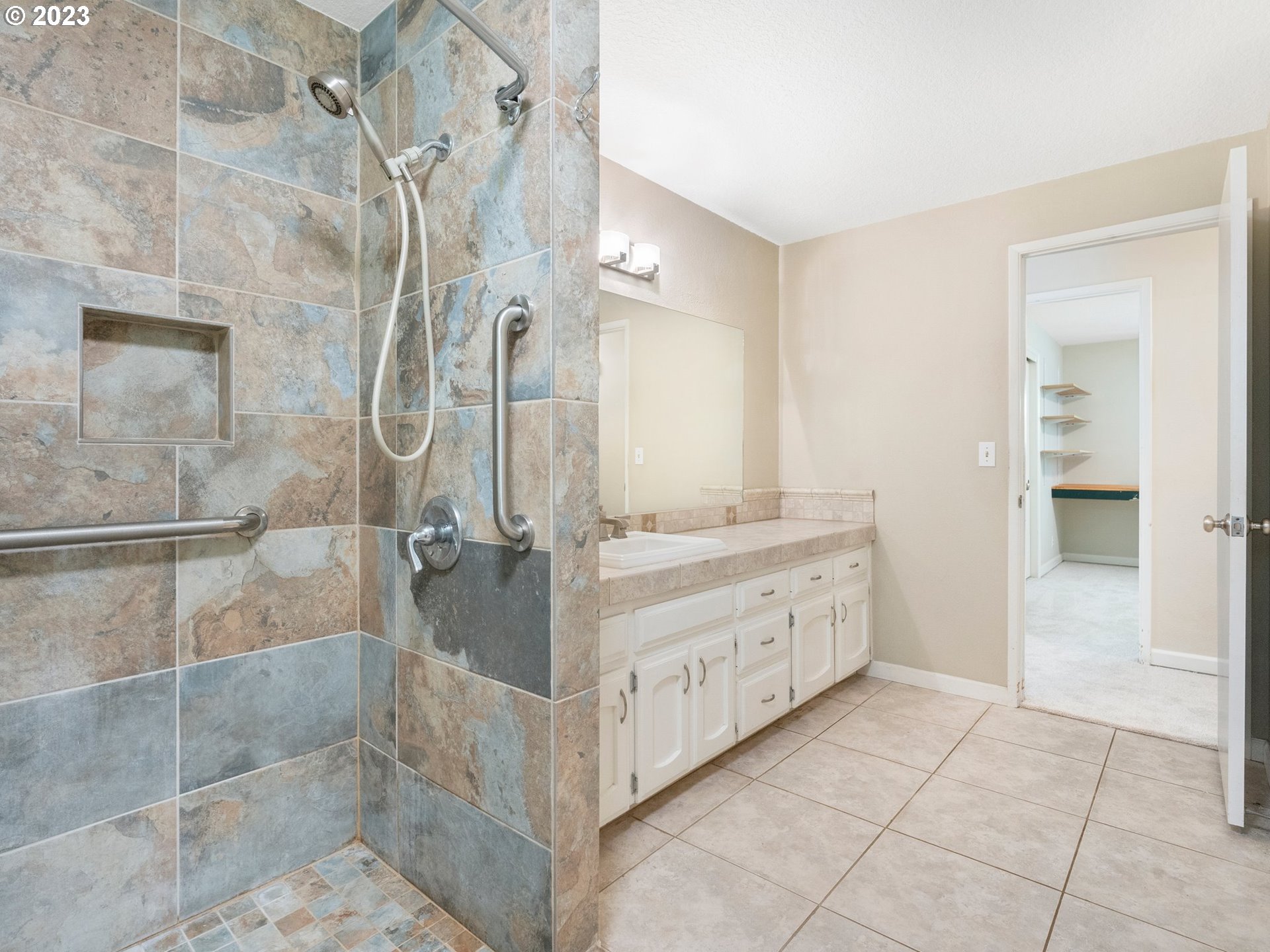 17875 Southwest Shawnee Trail Tualatin, OR 97062 - Photo 20 of 44 a bathroom with a granite countertop sink a mirror and a shower