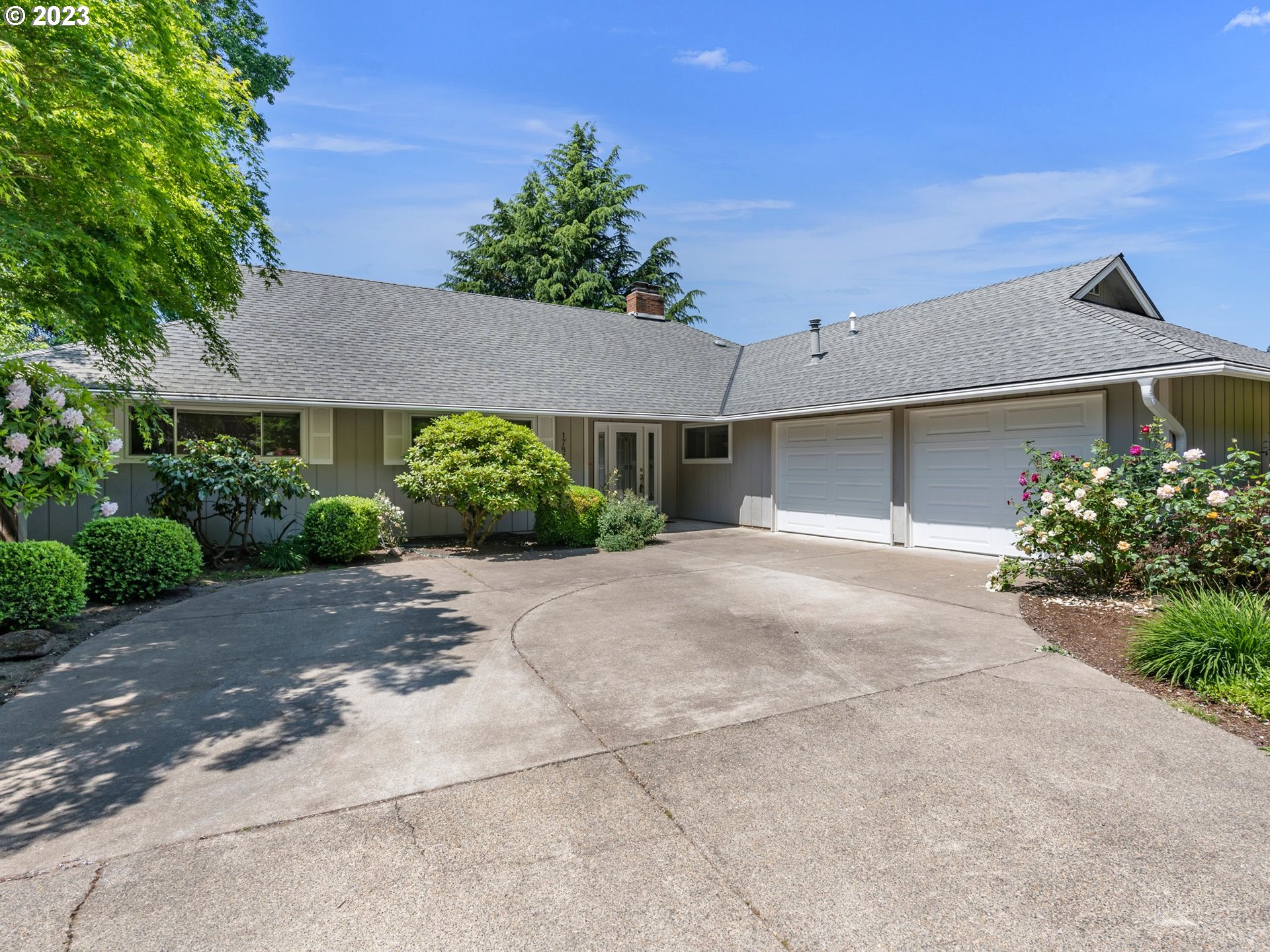 17875 Southwest Shawnee Trail Tualatin, OR 97062 - Photo 2 of 44 a view of a house with a yard and a garage