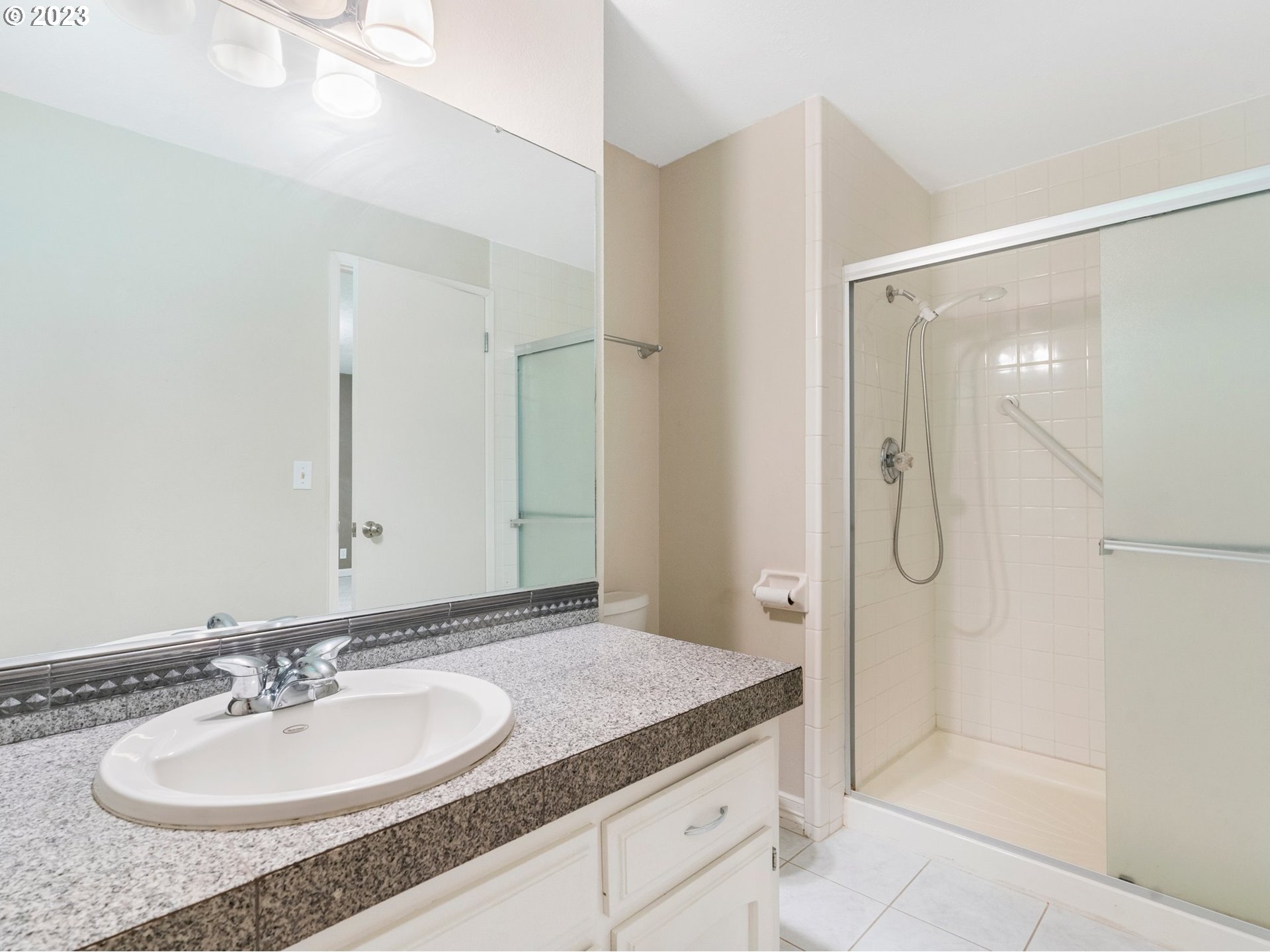 17875 Southwest Shawnee Trail Tualatin, OR 97062 - Photo 26 of 44 a bathroom with a granite countertop sink shower and a mirror