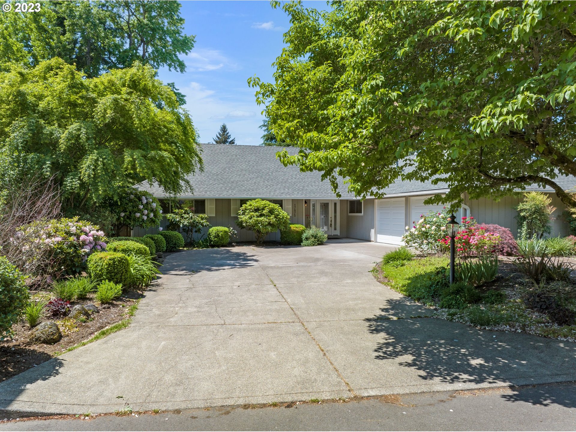 17875 Southwest Shawnee Trail Tualatin, OR 97062 - Photo 40 of 44 a front view of a house with a yard and a garden