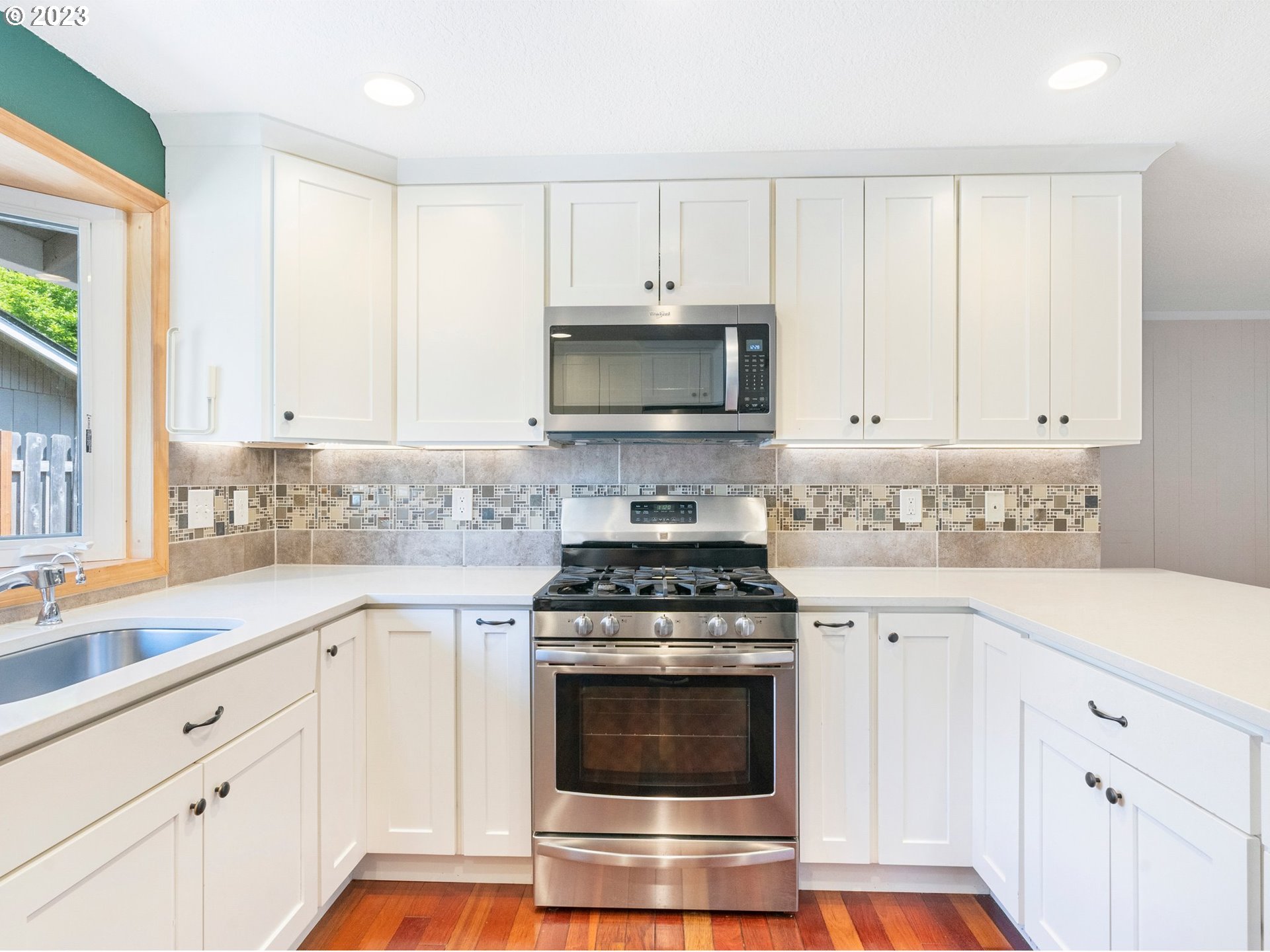 17875 Southwest Shawnee Trail Tualatin, OR 97062 - Photo 7 of 44 a kitchen with granite countertop white cabinets and white appliances