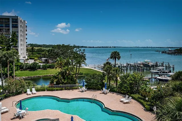 a kitchen with stainless steel appliances kitchen island granite countertop a refrigerator and a stove top oven