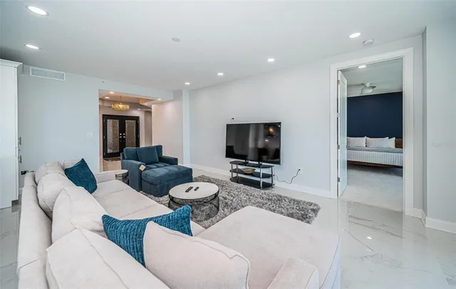 a kitchen with kitchen island a counter top space a sink stainless steel appliances and cabinets