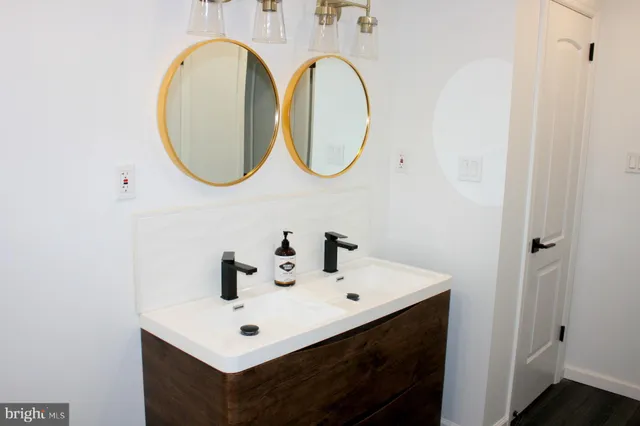 a bathroom with a sink a toilet and a mirror
