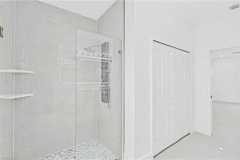 an empty room with a window and a ceiling fan