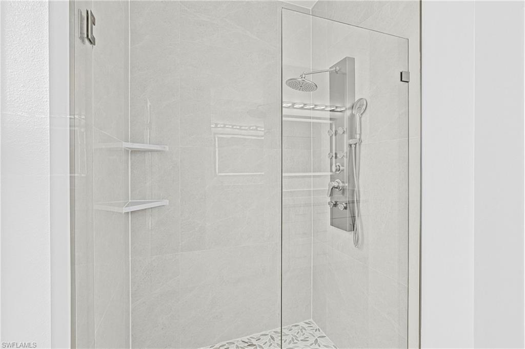 343 Pullman Street Lehigh Acres, FL 33974 - Photo 25 of 48 a bathroom with a glass shower door