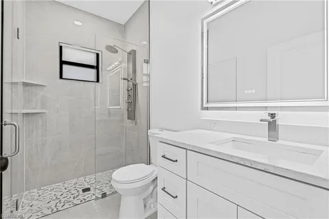 a bathroom with a sink toilet and shower