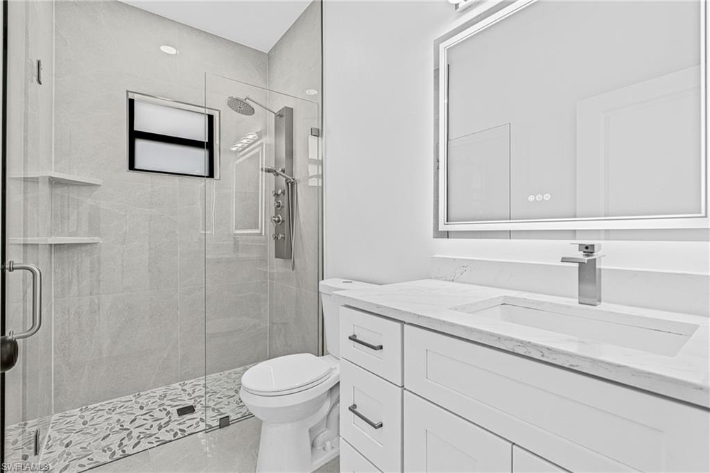 343 Pullman Street Lehigh Acres, FL 33974 - Photo 30 of 48 a bathroom with a sink toilet and shower