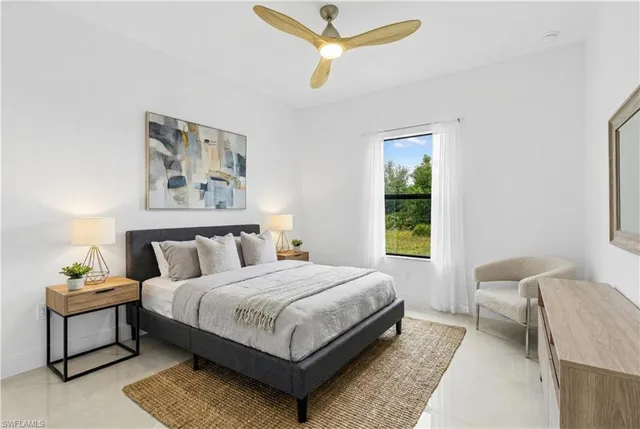 a bedroom with a bed a couch and a window