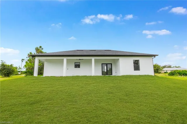 a house view with swimming pool in front of it