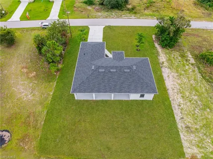 an aerial view of residential houses with outdoor space and swimming pool