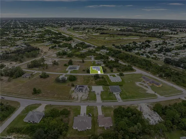 an aerial view of residential houses with outdoor space and swimming pool