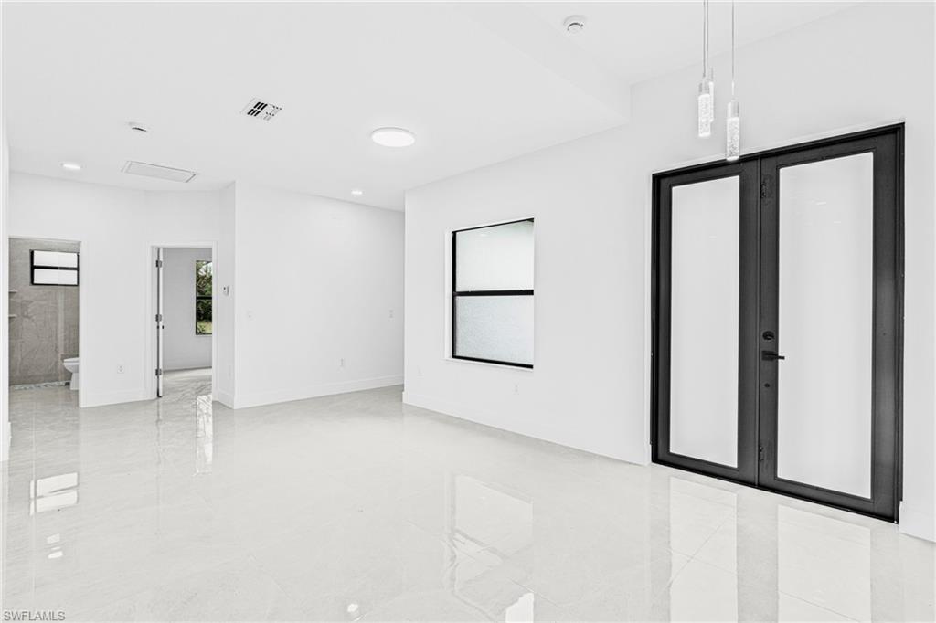 343 Pullman Street Lehigh Acres, FL 33974 - Photo 6 of 48 a view of an empty room with a window